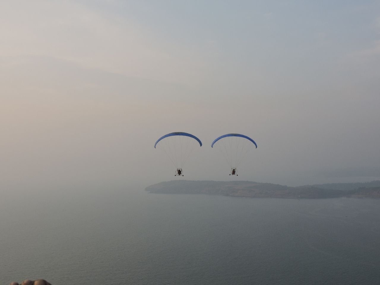 Group of friends enjoying paramotor rides at Ganpatipule beach.