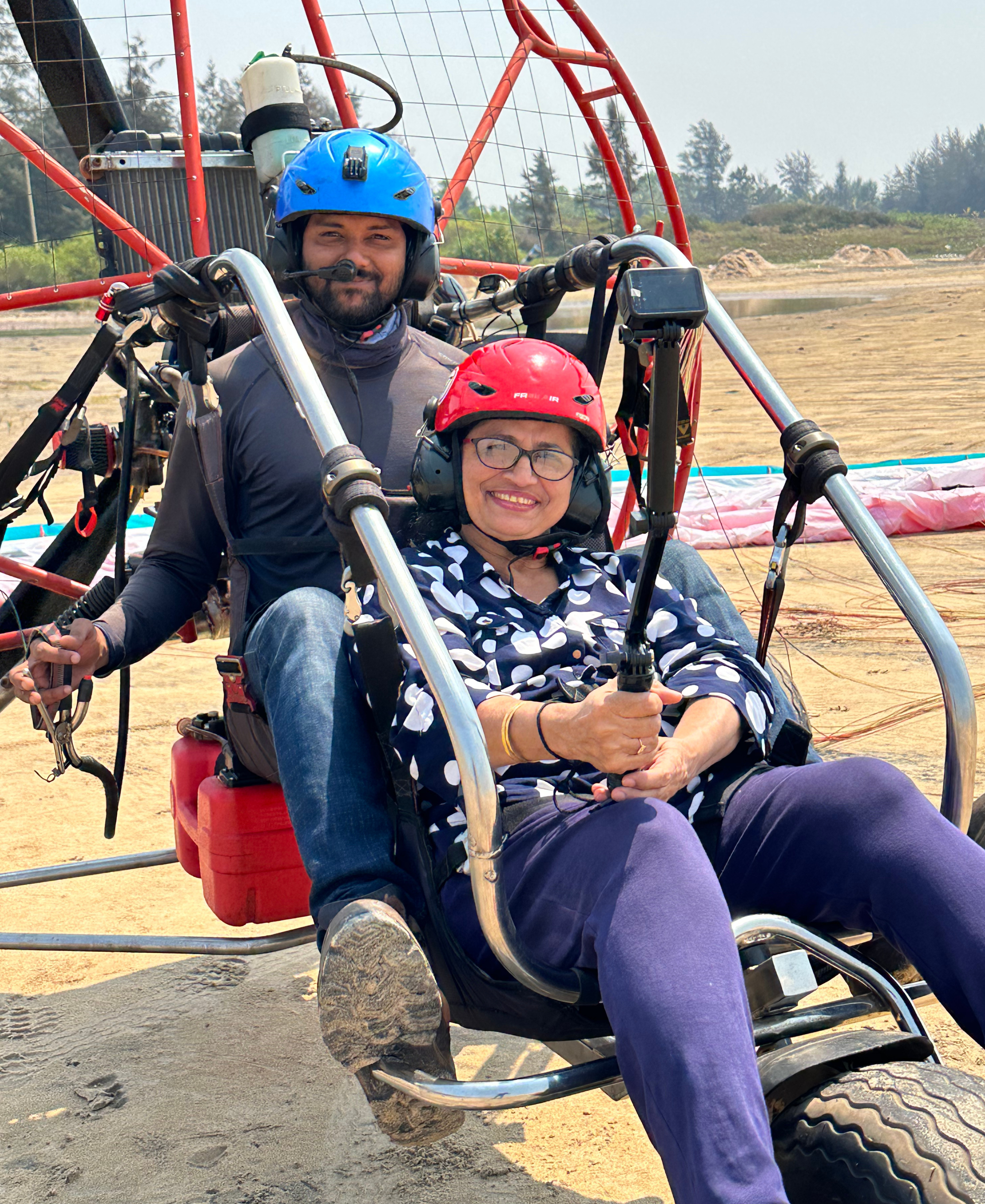 A person enjoying a safe paramotoring adventure ride over the beautiful Ganpatipule beach in Ratnagiri, Maharashtra with Paramotor India.
